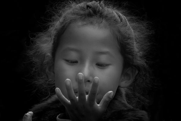 A Young Girl Looking at her Hands thumbnail