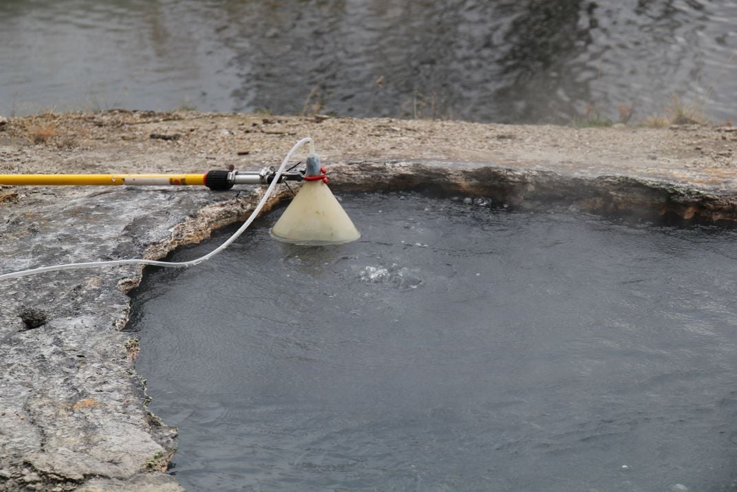 Gas bubbling up through a hot spring in Yellowstone National Park is collected through a funnel. Credit: J. Lowenstern, U.S. Geological Survey