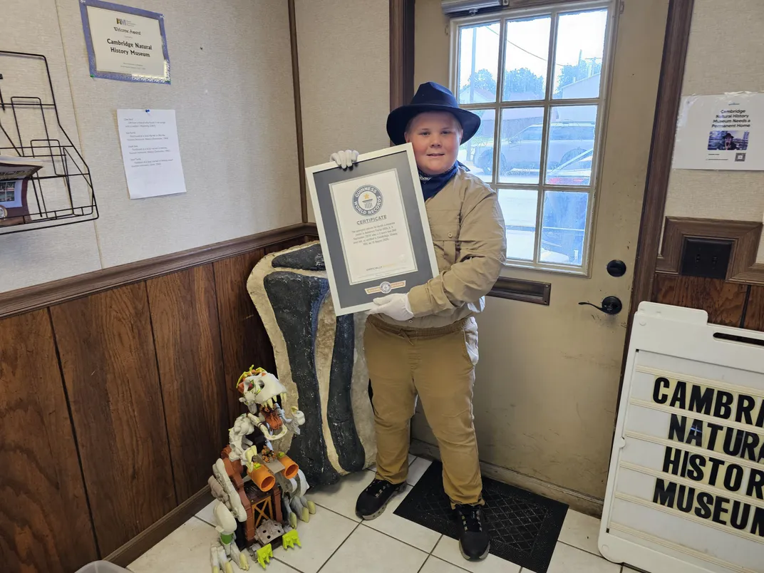 Boy stands with Guinness World Record award