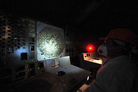 An employee of the Chernobyl Nuclear Power Plant walks in the control room of the destroyed 4th block of the plant on February 24, 2011, ahead of the 25th anniversary of the meltdown of reactor number four.