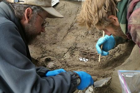 Archaeologists Ben Potter and Josh Reuther, both of the University of Alaska in Fairbanks, excavate the burial pit at the Upward Sun River site. 