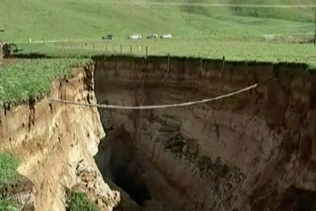 A spectacular sinkhole the length of two football fields and the depth of a six-story building has opened up on a New Zealand farm.