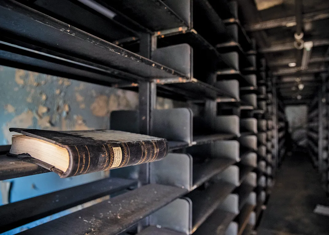 old shelves, empty, with one antique book resting on them