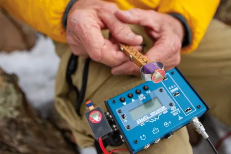 Steve Galchutt shows off the custom-made low-wattage transmitter he uses on his treks.