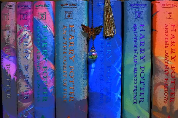 A set of books on a shelf with a bookmark hanging down from them. thumbnail