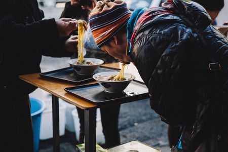 On a chilly day in Tokyo, customers slurp hot ramen at the Tsukiji fish market.
