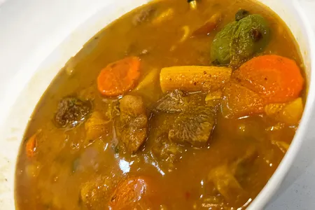 Soup joumou is a savory, orange-tinted soup that typically consists of calabaza squash, beef, noodles, carrots, cabbage, various other vegetables and fresh herbs and spices.
