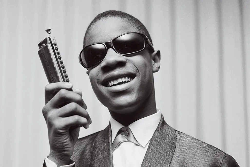 Stevie Wonder holding a harmonica