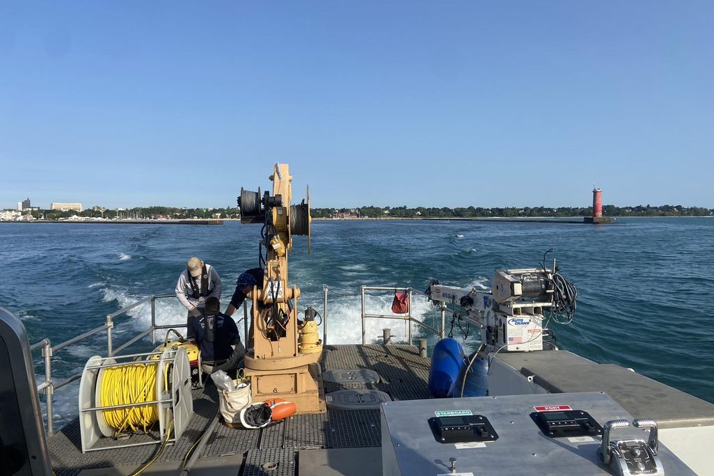 Back of a boat with equipment on it overlooked the water