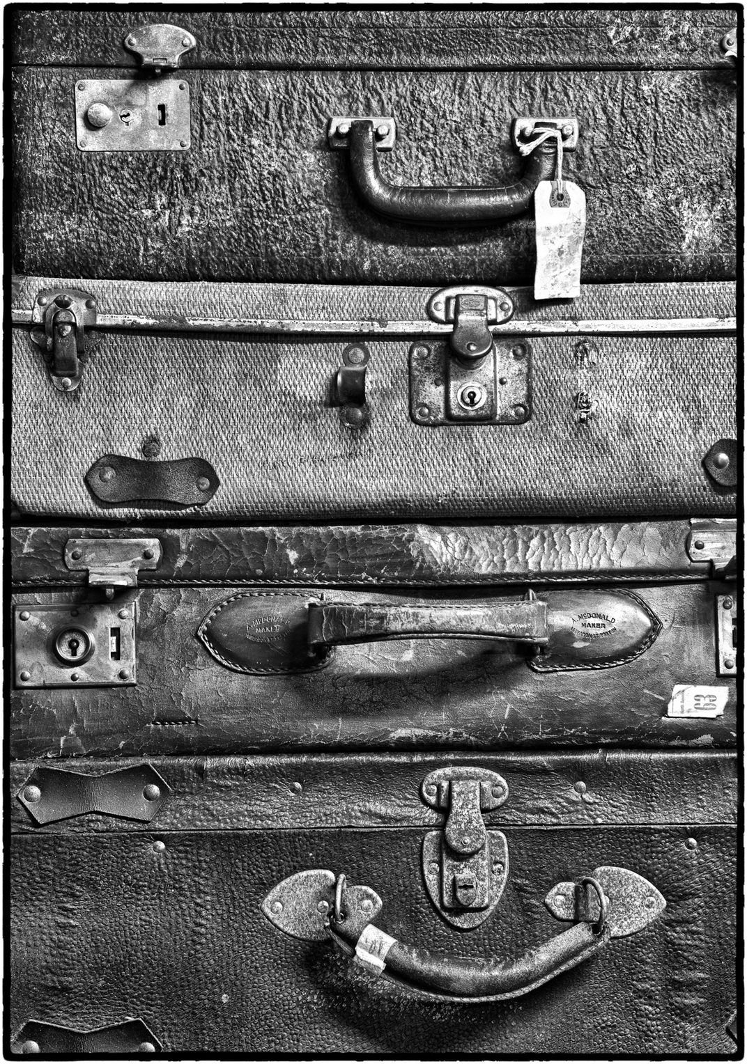 Stack of old suitcases in antique, junk store Smithsonian Photo