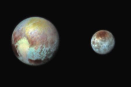 Exaggerating the colors on Pluto and Charon helps mission scientists see distinct terrains on each icy world.