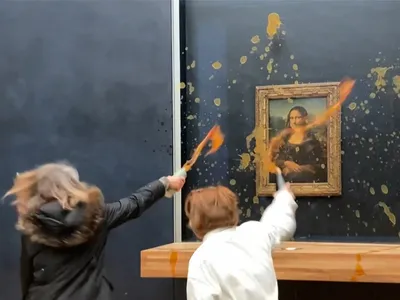 Protesters throw soup at the Mona Lisa&#39;s protective glass covering at the Louvre on January 28.