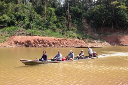 Paleontologists crossing the Rio Yurúa in Amazonian Perú, with the Santa Rosa fossil site in the background.