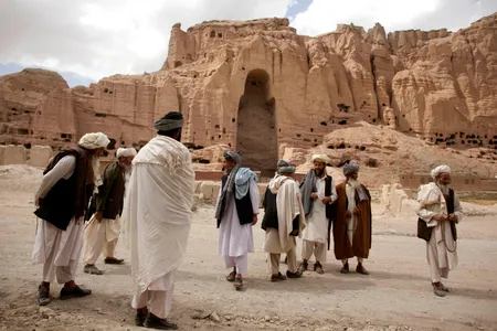 Afghan men stand near the ruins of the ancient Buddhas of Bamiyan.