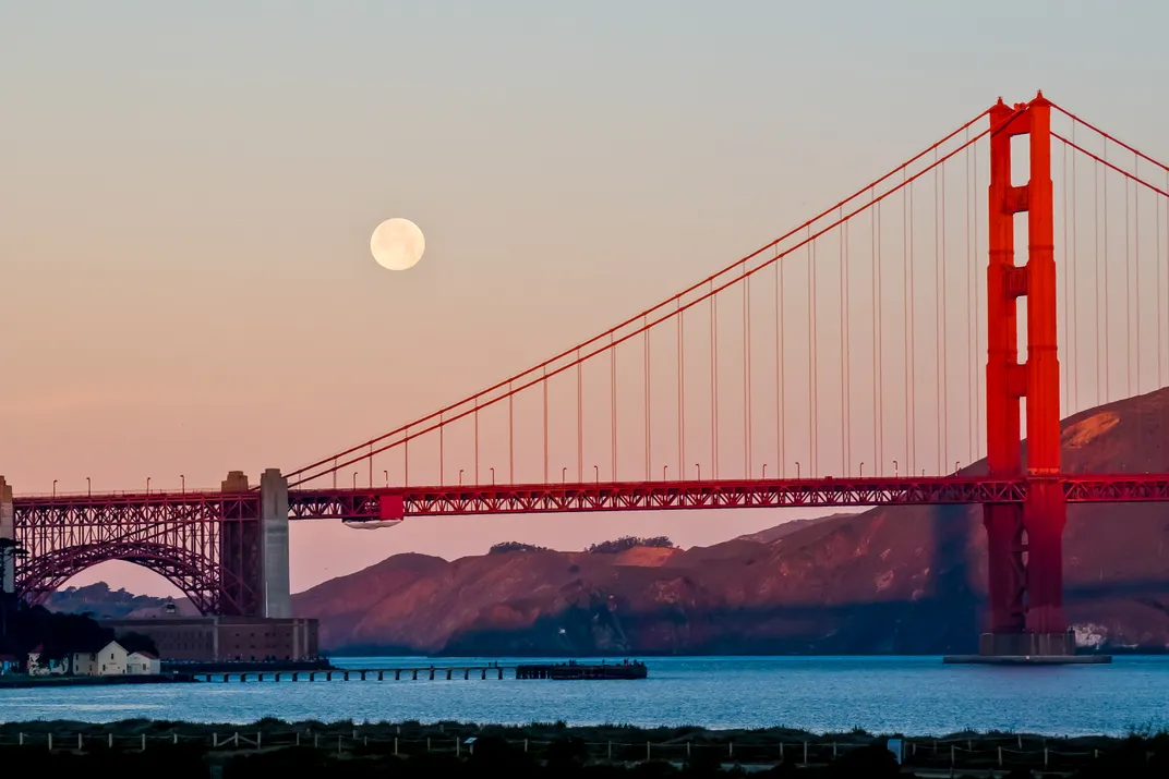 Golden Gate Bridge with big moon on the left side