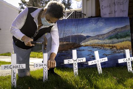 Julia Santos Solomon inserting crosses for her In Memoriam installation, Christ Lutheran Church, Woodstock, NY, 2020. Photo by Scott Barfield.