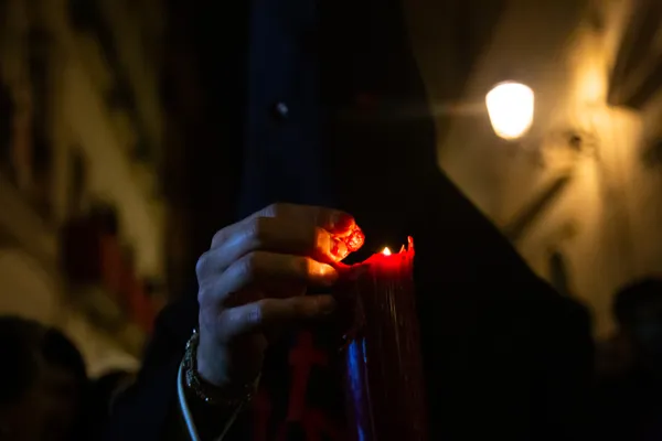 Catholic Devotee in Capirote Wields a Candle During Semana Santa thumbnail