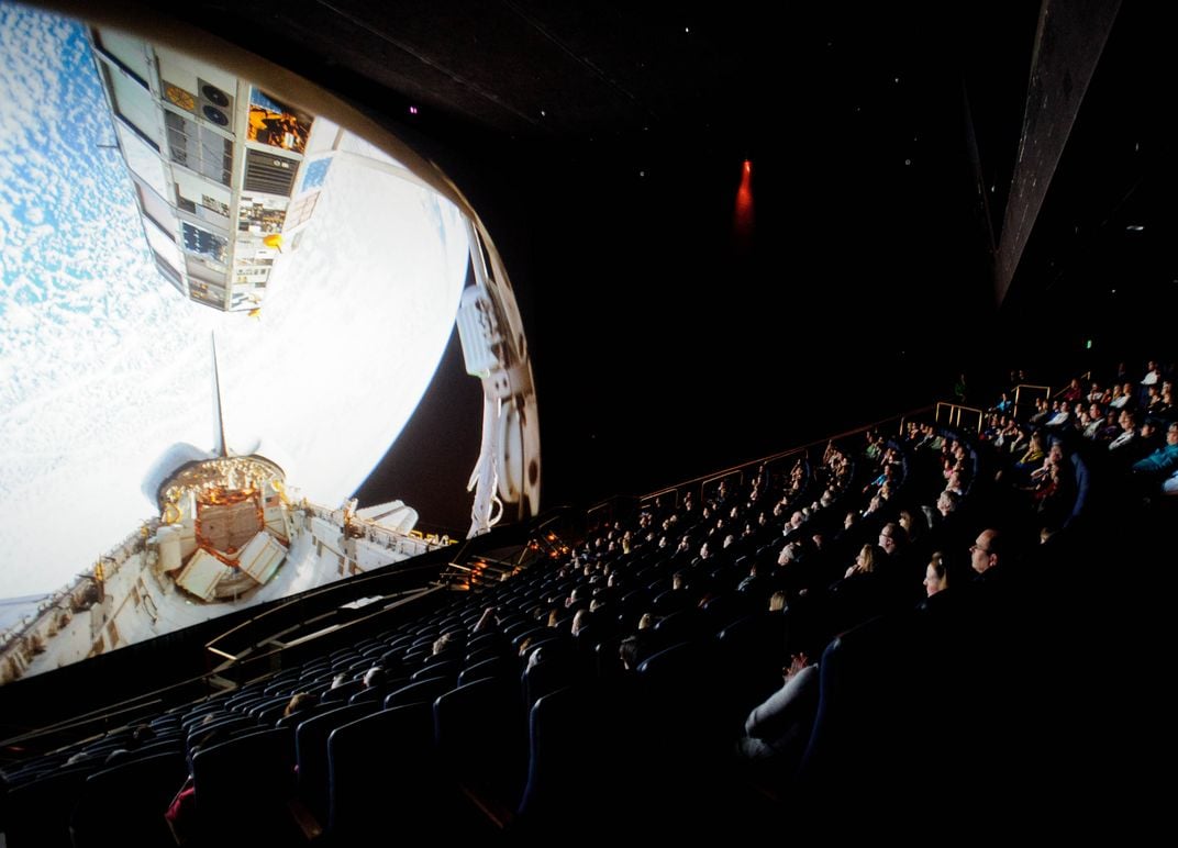 An audience watches The Dream is Alive at the National Air and Space Museum