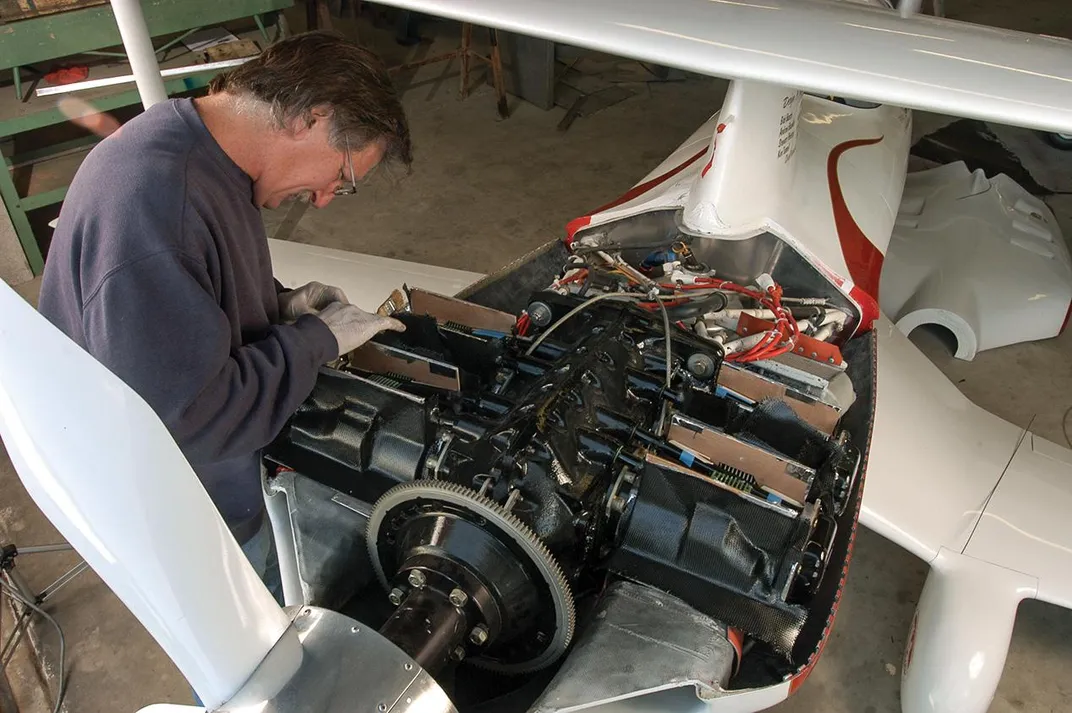 Andy Paterson works on air-cooling of biplane