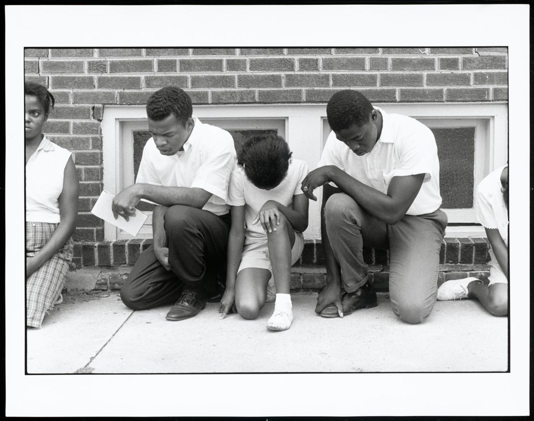 John Lewis prays during demonstration, 1962