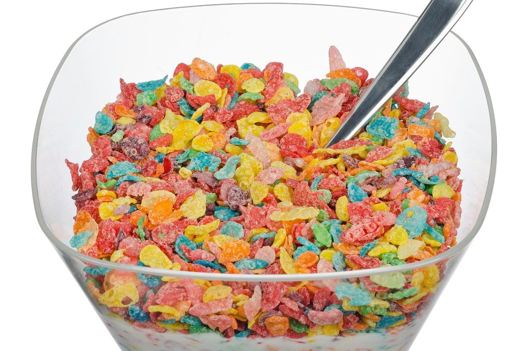 Fruity Pebbles cereal with milk in a clear plastic bowl.