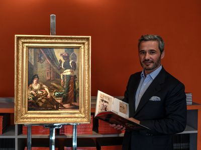 French gallerist Philippe Mendes poses next to Eugene Delacroix's lost preliminary painting of “Women of Algiers in Their Apartment."