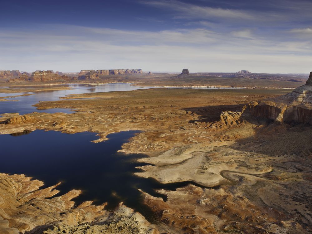 Arial image over lake powell with red rock formations and low water levels
