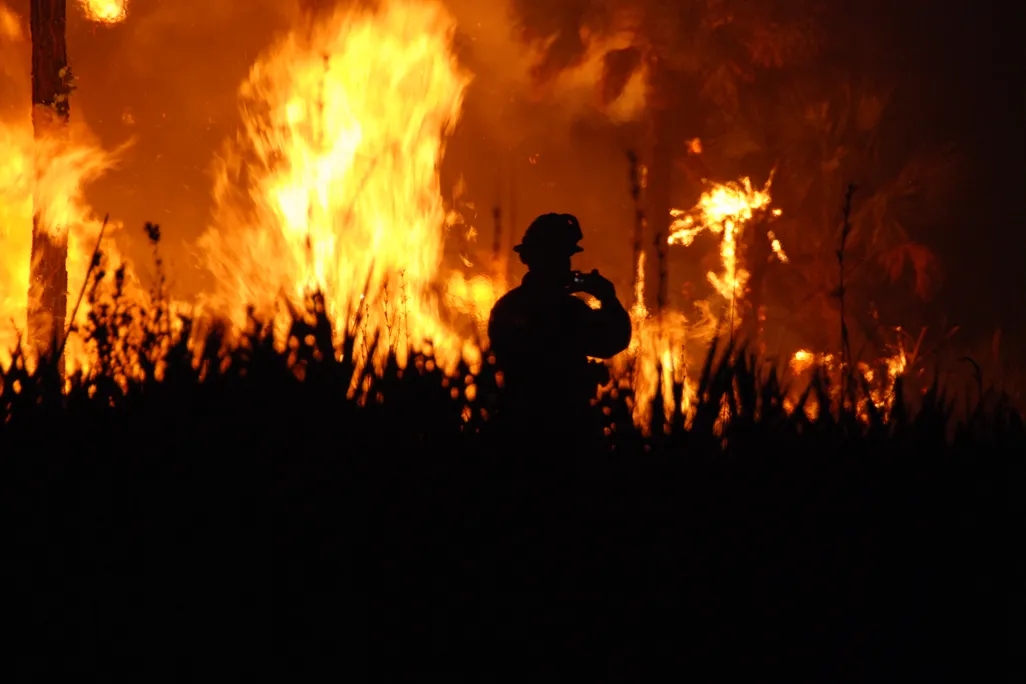 The silhouette of a firefighter at a blaze at the Florida Panther National Wildlife Refuge.