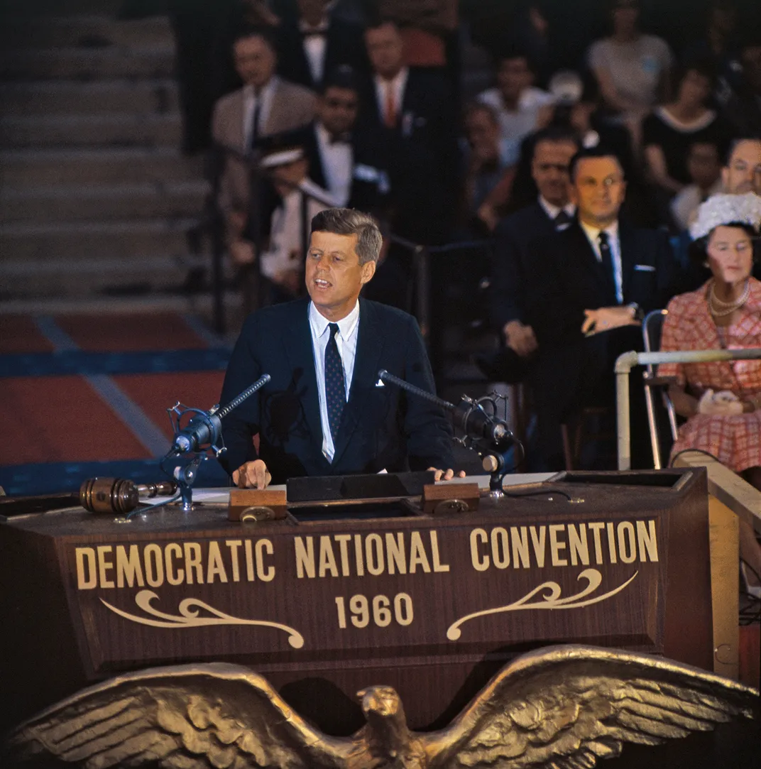 a man in a suit at a podium gives a speech
