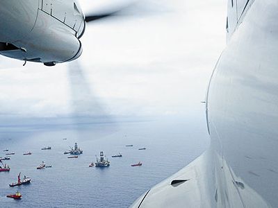 From the cockpit of a Coast Guard HC-144 patrol plane, the armada surrounding the deep water horizon rig last June appears placid.