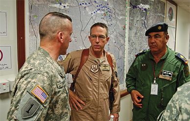 Brooks Bash (center) oversees the training of Iraqi pilots and ground crew.