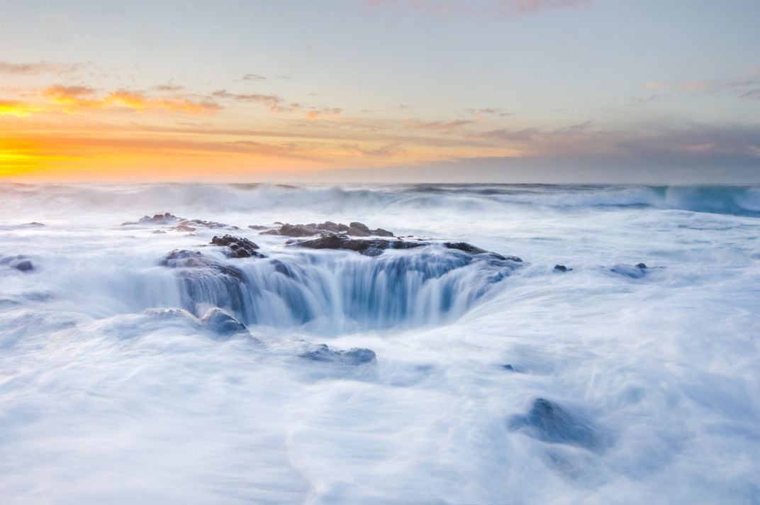 blurred waterfalls flow into a hole