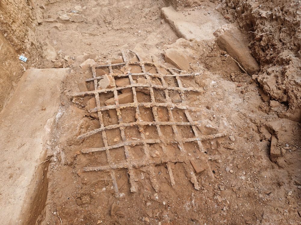 Iron bars covered in dirt on the ground