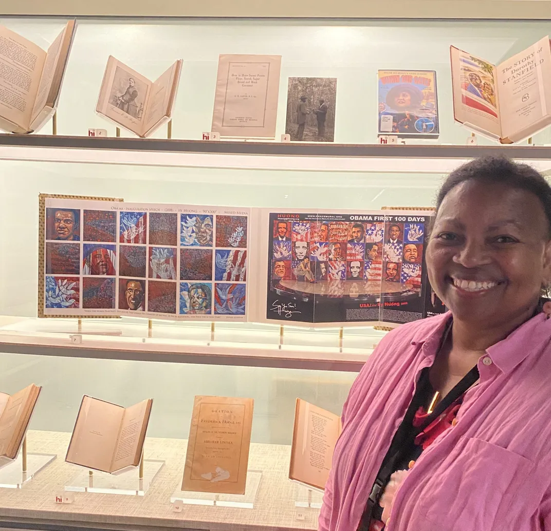 Shauna Collier stands next to library display.