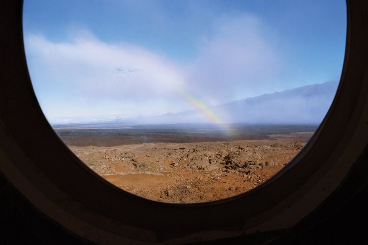 A rainbow on rugged landscape