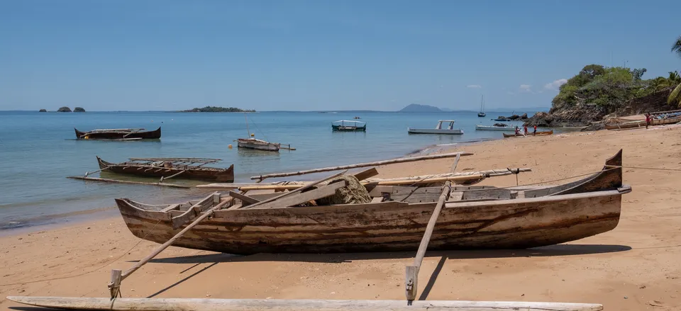  A traditional dugout with outriggers on a beach in Nosy Be, Madagascar 