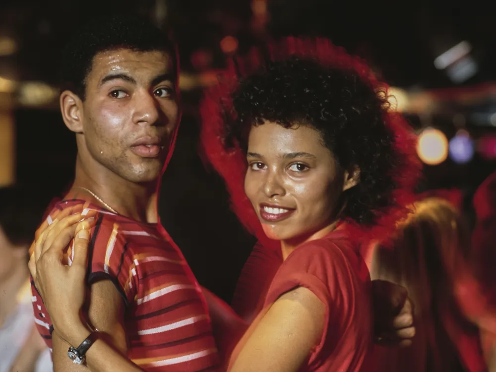 Two disco fans dancing together at a club, circa 1975