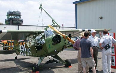 A Piper L-4 Grasshopper demonstrates the Brodie System, in which an aircraft snagged a trolley that ran along a cable in order to land on a short strip or a ship.