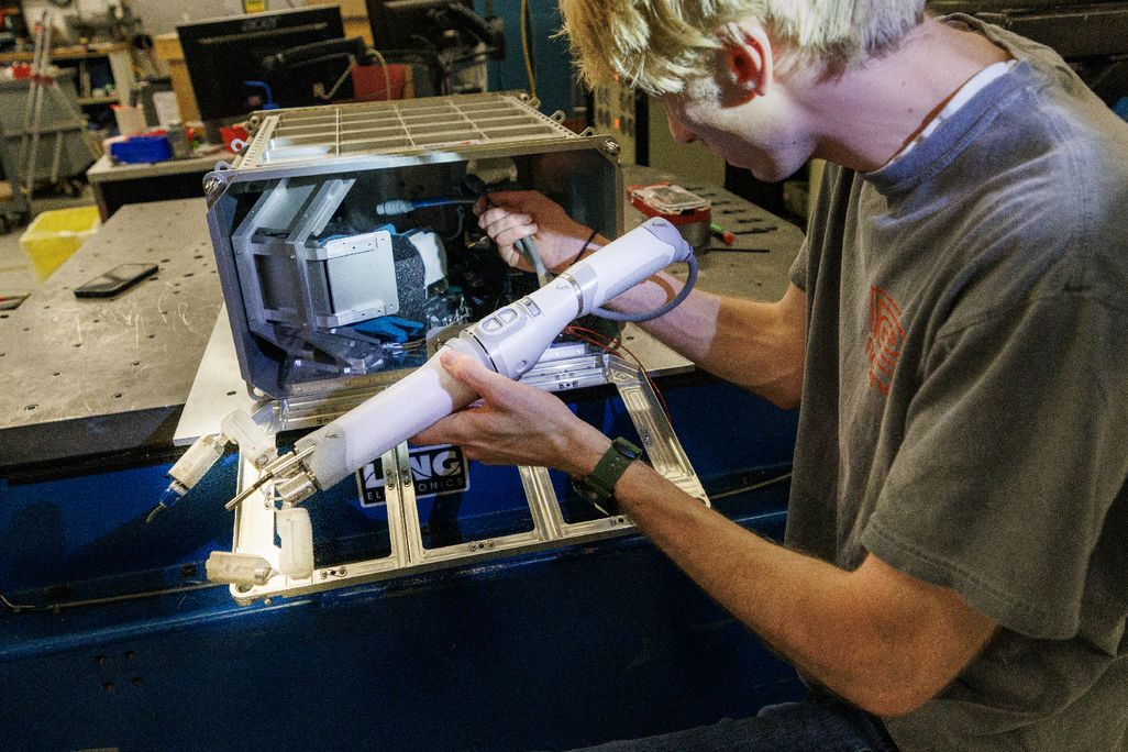 A person holding a robotic arm