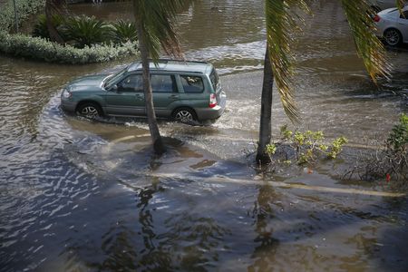 Similar lunar and climate conditions led to increased flooding in 2015. Pictured, a car drives through high waters in Fort Lauderdale, Florida.