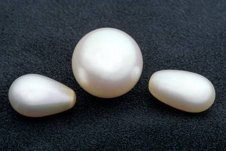 Smooth pearls in the shape of orbs and ovals are usually created by bivalves, like mussels, in pearl farms. As with all gems, the less blemishes they have, the more valuable they are. (Chip Clark, Smithsonian)