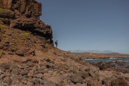 Geochemist Blake Dyer observes the north shore of Molokai.