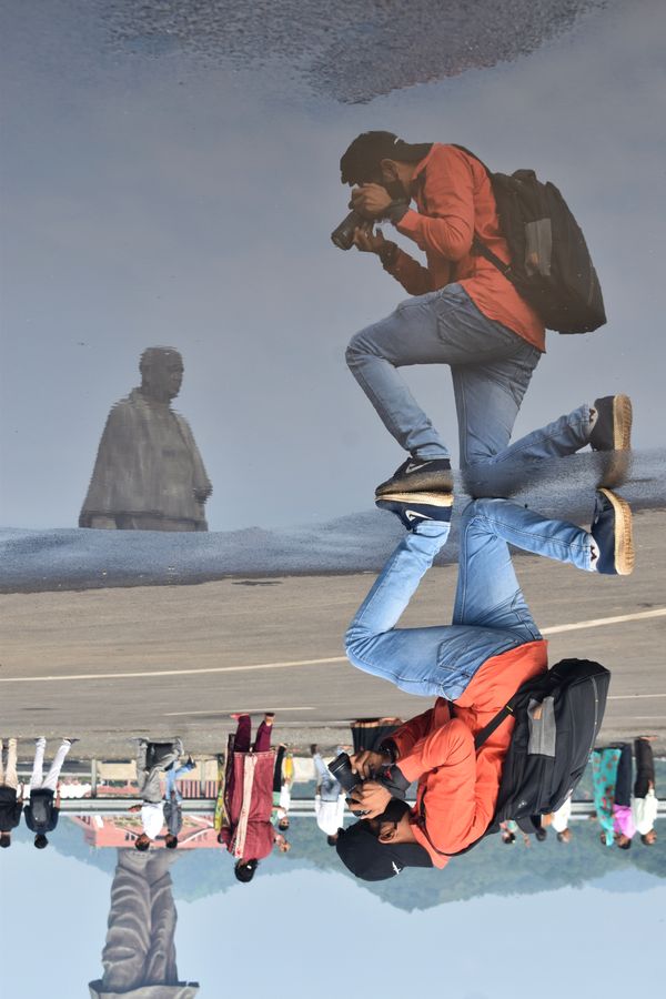 A photographer clicking a reflection of the world's largest statue thumbnail