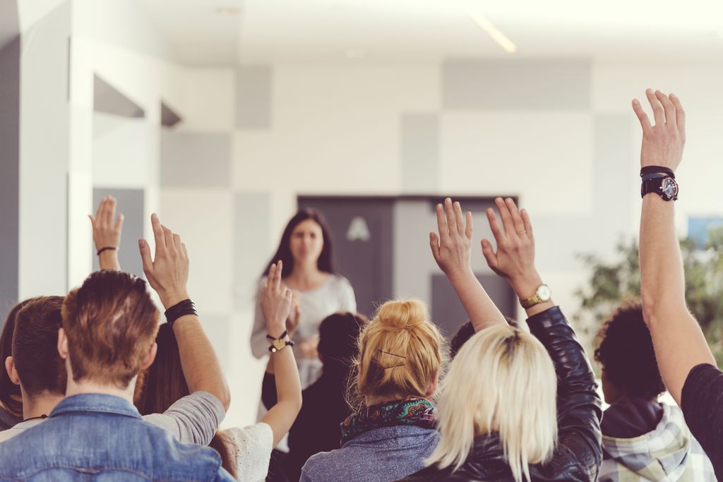 students raising hands