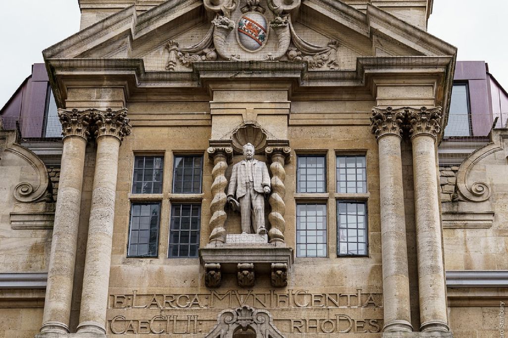 Statue of Rhodes on side of college building