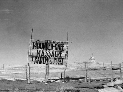 Dating from 1940, this photograph depicts a sign at the site of the Wounded Knee Massacre, South Dakota, where 250 American Indians were killed in 1890.