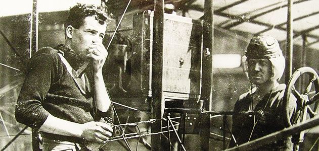 Just months after Lieutenant Paul Beck made an early airborne radio transmission, aviators test a receiving set - with the airplane's engine running - on North Island, Washington.