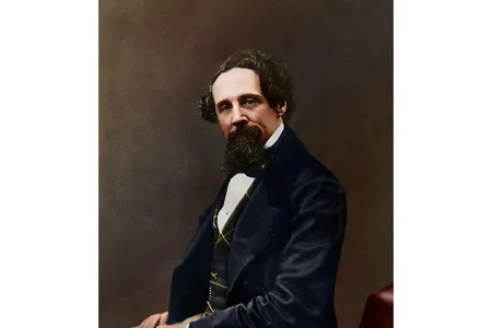 The colorized photograph shows 47-year-old Dickens in a blue, green and yellow waistcoat; a navy blue jacket; and tan trousers.