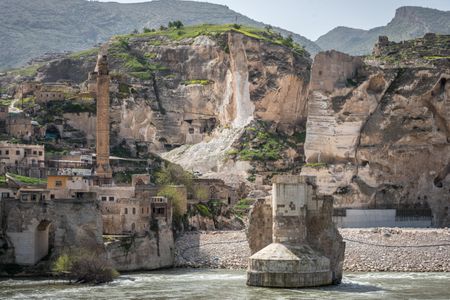 The ancient Silk Road trading post of Hasankeyf, which sits on the banks of Tigris River in southeast Turkey, will soon be flooded by the Ilisu Dam. Picture here, Construction crews destroy limestone cliffs around Hasankeyf that are dotted with neolithic caves in preparation for submerging later this summer