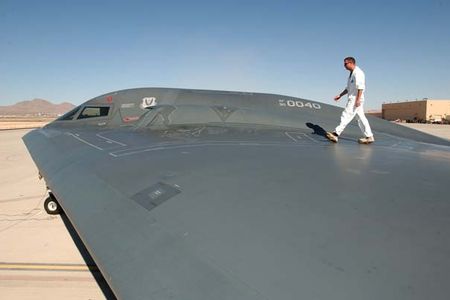 AFIE  --  Structural Maintenance Tech. Sgt. Kevin Ponton, examines the wing surface of a B-2 Spirit Bomber at Nellis Air Force Base, Nevada on Oct. 21st.  Ponton is a member of the 509th Aircraft Maintenance Squadron from Whiteman Air Force Base, Missouri.  He and several other personnel from Whiteman were sent on temporary duty to Nellis to maintain the B-2 Spirit Bombers that are participating in EXERCISE Red Flag 04-01.  Red Flags are war exercises that allow combat aircrews training in the most realistic simulated war environment possible.  (U.S. Air Force photo by MSgt Michael R. Nixon)   Released.  VIRIN: 031021-F-3356N-010